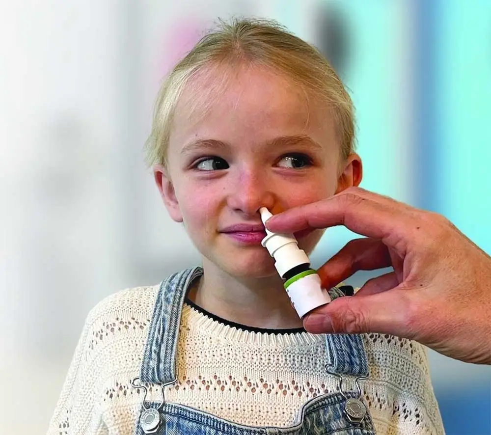 a doctor administers pain relief through a nasal spray